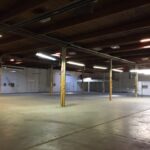 Seattle Area Warehouse Poorly And Unevenly Lit With Outdated Fluorescent Fixtures